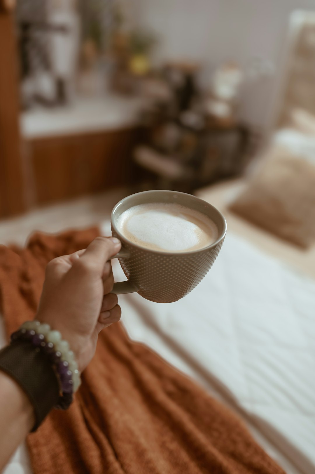 Woman relaxing with a drink at home, representing mental space beyond constant thoughts about food