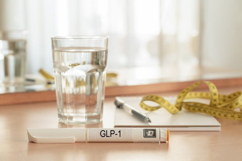 GLP-1 injection pen with water and measuring tape