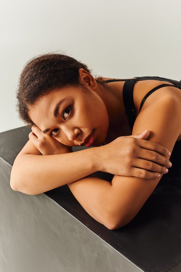 Woman resting with her head on her arms