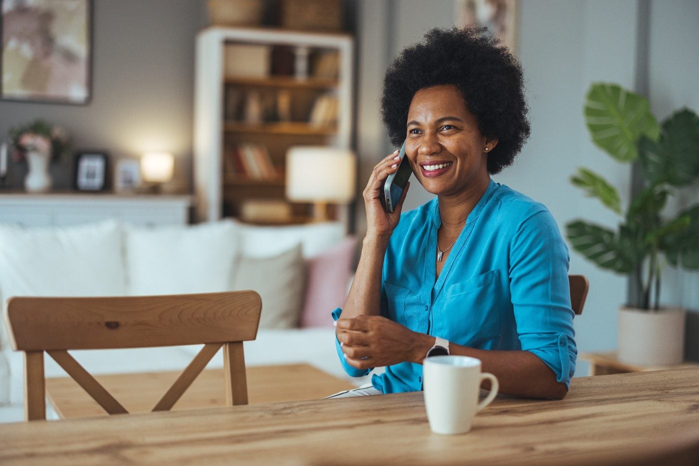 Woman speaking on the phone at home